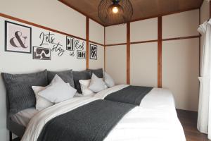 a bedroom with two beds with black and white pillows at KiyosuBase2 in Kiyosu