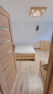 a room with a bed and a door at Tatra Lodge Apartamenty z widokiem na góry in Kościelisko