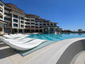 a large swimming pool in front of a building at SoleMare One-Bedroom Apartment in Burgas