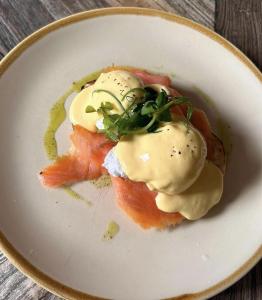 a plate of food with eggs on top of salmon at Florence Suite Boutique Hotel and Restaurant in Portsmouth +60 photos