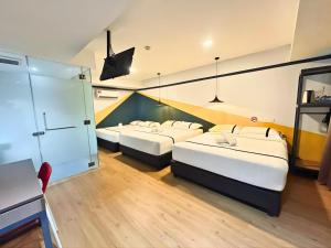 a hotel room with three beds and a staircase at Seeds Hotel Selayang in Batu Caves +14 photos