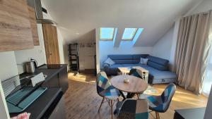 a living room with a blue couch and a table at Apartamenty Intermo Górna 7 in Świętochłowice