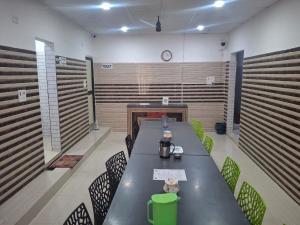 a room with a long table and chairs and a fireplace at Budget Hotel in Patna