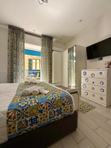 a bedroom with a bed with a colorful comforter at Ballaro's Vibe Historical Apartment Cathedral District in Palermo