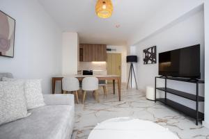 a living room with a couch and a table at SoleMare One-Bedroom Apartment in Burgas