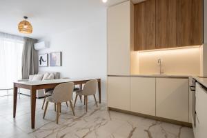 a kitchen and dining room with a table and chairs at SoleMare One-Bedroom Apartment in Burgas