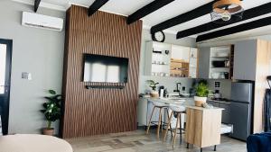 a kitchen with a wooden door with a table and stools at Maison De luxe in Thohoyandou