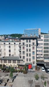 a large white building with a parking lot in front of it at CoCo Apartment in Ljubljana