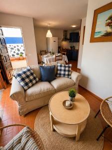 a living room with a couch and a table at El Molino Agaete in Puerto de las Nieves