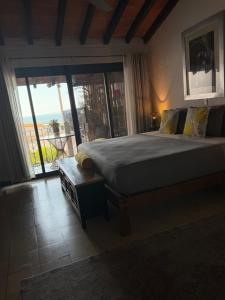 a bedroom with a bed with a view of the ocean at Casa Portillo in Puerto Vallarta