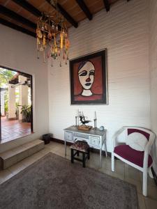 a room with a table and a chair and a painting at Casa Portillo in Puerto Vallarta +27 photos