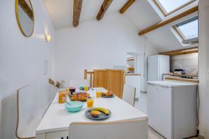 a kitchen with a table with food on it at COLIVING - bedroom Salon & TV in Saint-Jean-de-Gonville +9 photos