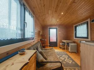 a living room with a couch and a table at RED Tiny Houses in Voronet