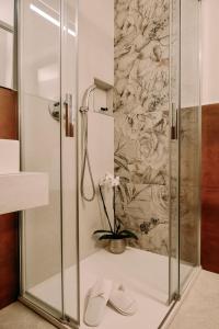 a shower with a glass door in a bathroom at Emilia381 Suite in Anzola dell'Emilia +51 photos