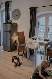 a child playing with a toy on the floor in a living room at Landgut zur Mühle in Dorfen