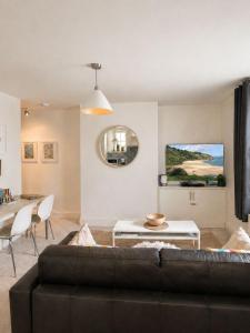 a living room with a couch and a table at Trinity Mews in Torquay
