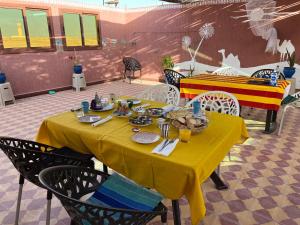 a yellow table with plates of food on it at Birgits Bed & Bistro, Garage für Biker kostenlos in Meski