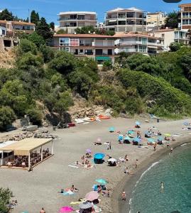 a group of people on a beach with umbrellas at Camino de Santiago Can Pau Costa Brava in Llança +4 photos