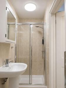 a bathroom with a shower and a sink at Trinity Mews in Torquay +95 photos