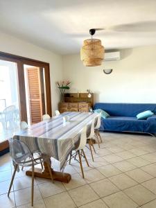 a living room with a table and a blue couch at Apartment Blue Bay in Malinska