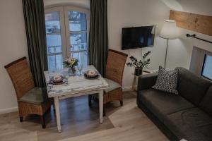 a living room with a table and a couch at Landgut zur Mühle in Dorfen
