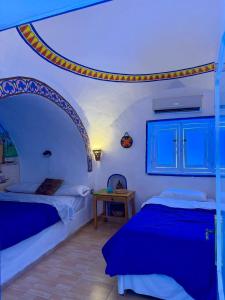 two beds in a room with an arch above them at Al Baeirat Hotel in Luxor +61 photos