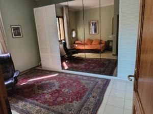 a room with a mirror and a living room at L'Antica Dimora Toscana in Cecina