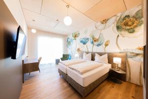 a bedroom with a bed with a flower mural on the wall at CIRCLE Boutique Hotel Melk in Melk