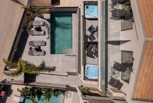 an overhead view of a building with a swimming pool at Old Cinema Suites - Stylishly Decorated Retreat with Pool or Jacuzzi by the Sea in the Heart of Laganas Βy Villa Mana Gers in Laganas +150 photos