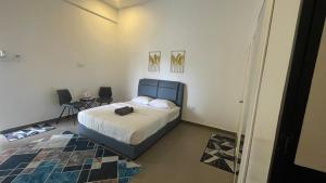 a bedroom with a bed and two chairs in it at Hotel O HNR INN in Kuala Terengganu +18 photos