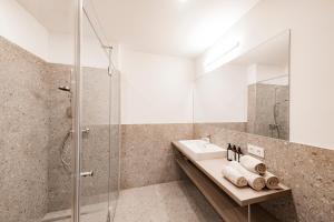 a bathroom with a sink and a shower at CIRCLE Boutique Hotel Melk in Melk +39 photos