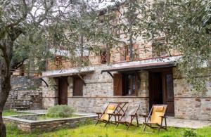 a group of chairs sitting outside of a building at Alexis new villas in Chrysi Ammoudia