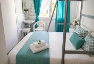 a bedroom with a bed with a cat in a towel at Camino de Santiago Can Pau Costa Brava in Llança