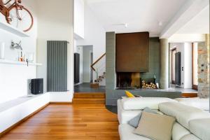 a living room with a couch and a fireplace at San Venanzo – Casale De' Conti in San Venanzo