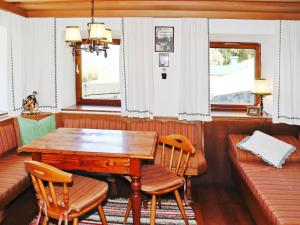 a dining room with a wooden table and chairs at Farmhouse in Kössen near Kitzbühel Alps in Kössen