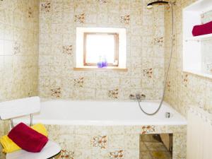 a bathroom with a bath tub and a window at Farmhouse in Kössen near Kitzbühel Alps in Kössen +5 photos