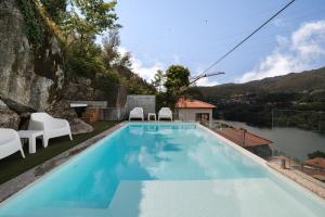 a swimming pool with a view of a mountain at Casa Pinhão De Sousa in Vieira do Minho