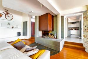 a living room with a couch and a fireplace at San Venanzo – Casale De' Conti in San Venanzo