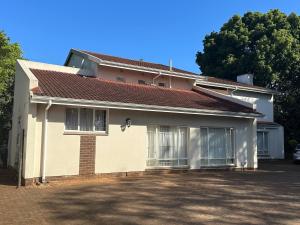 a white house with a red roof at Spacious 4BR Home Pool Balconies Krantzkloof in Kloof
