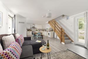 a living room with a couch and a table at Aval Dor Barn, Hot Tub, Pet Friendly in Ludgvan