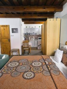 a large bed in a room with a kitchen at Pension Archa in Znojmo