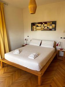 a bedroom with a bed with two towels on it at Casa Martello in Levico Terme