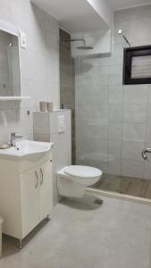 a bathroom with a toilet and a sink and a shower at Laki-in in Meljine