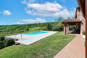 a backyard with a swimming pool and a gazebo at San Venanzo – Casale De' Conti in San Venanzo