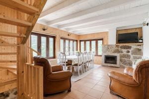 a living room with a table and chairs and a fireplace at Casa Pinhão De Sousa in Vieira do Minho