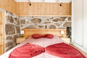 a bedroom with a large bed with red pillows at Casa Pinhão De Sousa in Vieira do Minho +22 photos