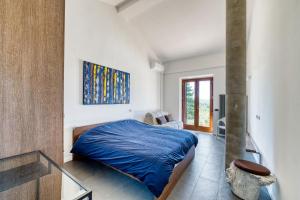 a bedroom with a blue bed in a room at San Venanzo – Casale De' Conti in San Venanzo +32 photos