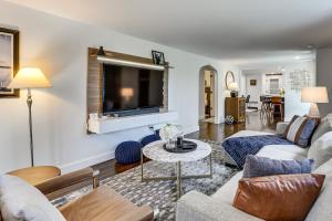 a living room with a couch and a tv at Charming Connecticut Hideaway: Year-Round Fun! in Middlefield