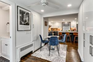 a dining room with a table and chairs and a kitchen at Charming Connecticut Hideaway: Year-Round Fun! in Middlefield