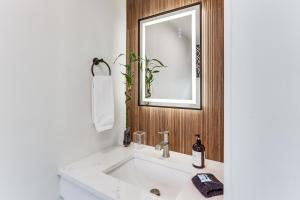 a bathroom with a white sink and a mirror at Charming Connecticut Hideaway: Year-Round Fun! in Middlefield +17 photos